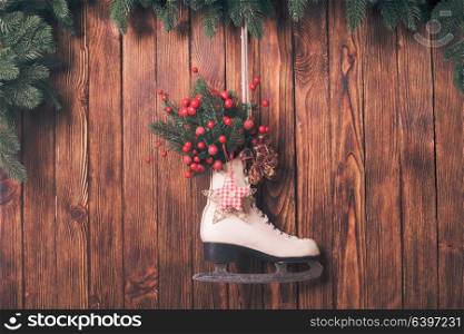 Christmas decorated skate on the wooden wall. Christmas decorated skate