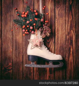 Christmas decorated skate on the wooden wall. Christmas decorated skate