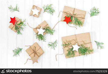 Christmas decoration and gift boxes on bright wooden background. Flat lay