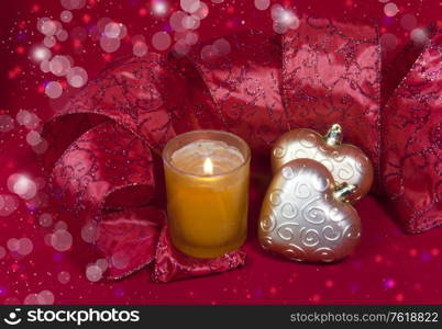 Christmas decoration- ball in shape a heart with ribbon and a candle