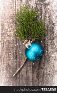 Christmas decoration ball on textured grungy wooden surface