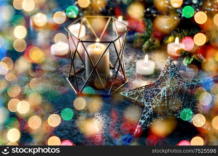 Christmas decoration candles and stars. Greetings card with defocused lights