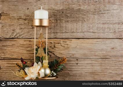 Christmas decoration candlestick on the old wooden background