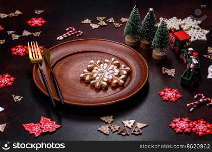 Christmas decoration elements as well as gingerbread on a brown concrete background. Preparing a festive table. Christmas decoration elements as well as gingerbread on a brown concrete background