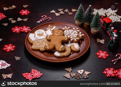 Christmas decoration elements as well as gingerbread on a brown concrete background. Preparing a festive table. Christmas decoration elements as well as gingerbread on a brown concrete background