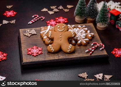 Christmas decoration elements as well as gingerbread on a brown concrete background. Preparing a festive table. Christmas decoration elements as well as gingerbread on a brown concrete background