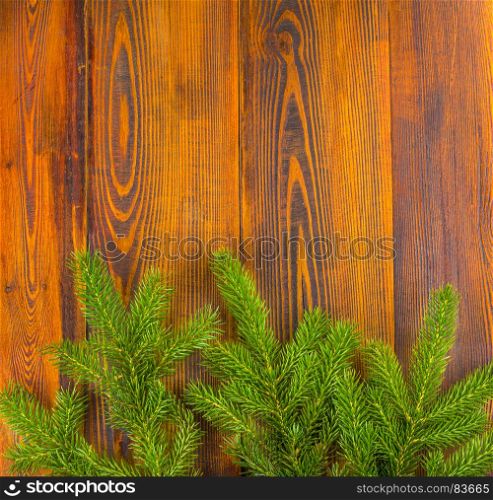 Christmas decoration, frame concept background, top view on natural rustic wood table surface. Fir tree branches border with copy space