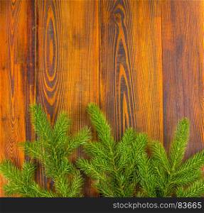 Christmas decoration, frame concept background, top view on natural rustic wood table surface. Fir tree branches border with copy space