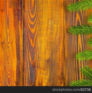 Christmas decoration, frame concept background, top view with copy space on natural rustic wood table surface. Christmas border with fir tree branches