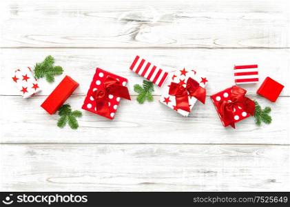 Christmas decoration gift box and pine tree branches on bright wooden background
