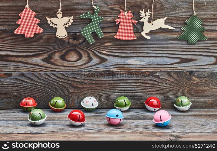 Christmas decoration hanging over wooden background and jingle bells