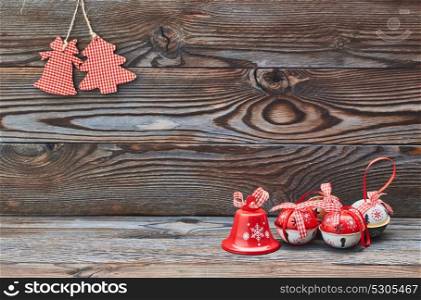 Christmas decoration hanging over wooden background and jingle bells
