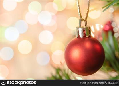 Christmas decoration. Hanging red balls on pine branches Christmas tree garland and ornaments over abstract bokeh background with copy space