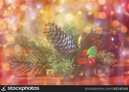christmas, decoration, holidays and new year concept - close up of natural fir branch decoration and fir-cone and lantern on wooden table over lights