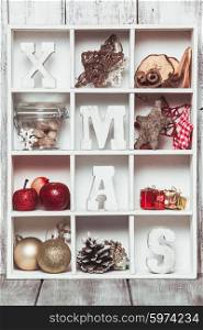 Christmas decoration in a wooden box. Cozy holiday in home. Wood letters XMAS in shadow box memories. Christmas box