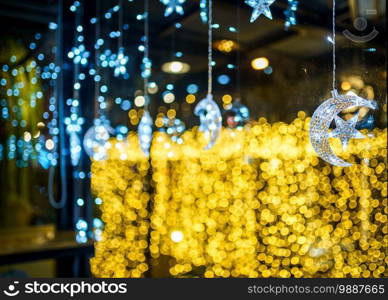 Christmas decoration lights in the crescent moon and shape of a star for with rope on Bokeh background Decoration During Christmas and New Year.