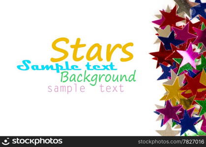 Christmas decoration of colored confetti stars against white background