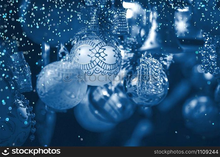 Christmas decoration on an european market. Holiday shopping. Color of the year 2020 classic blue toned postcard