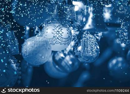 Christmas decoration on an european market. Holiday shopping. Color of the year 2020 classic blue toned postcard