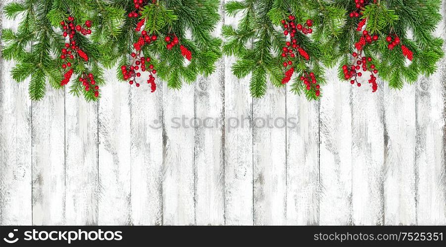 Christmas decoration on bright wooden texture. Winter holidays border