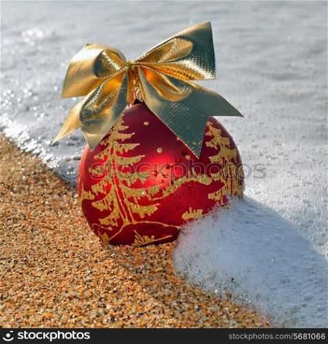 Christmas decoration on the beach against ocean wave