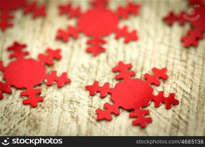 Christmas decoration. Red snowflakes close up on weathered wood background