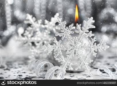 Christmas decoration, silver holiday background with candle &amp; snowflake