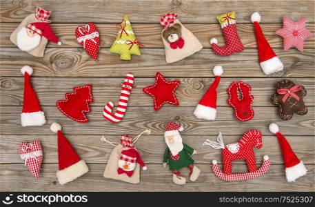 Christmas decoration textile handmade toys hanging over rustic wooden background