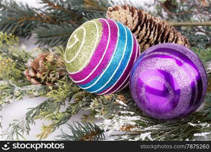 Christmas decoration with balls, cone and fir-tree branch.
