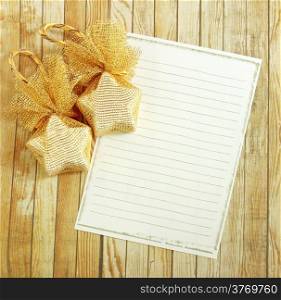 Christmas decoration with blank notebook over wooden background
