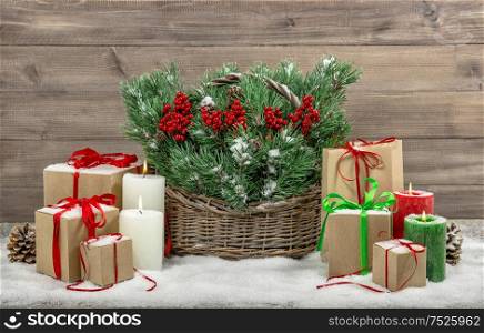 Christmas decoration with burning candles and gift boxes. Vintage style still life