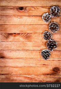 Christmas decoration with cones on wooden background