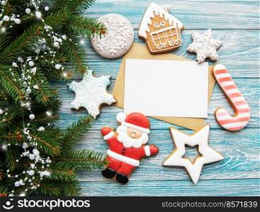 Christmas decoration with cookies and greeting card on a wooden background