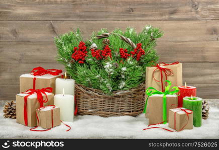 Christmas decoration with gift boxes and burning candles. Nostalgic still life