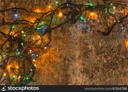Christmas decoration with lighting, on an old wooden background