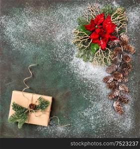Christmas decoration with red flowers and wrapped gifts. Holidays background