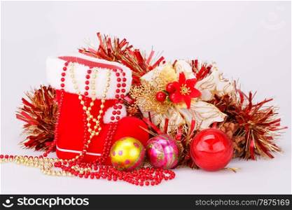 Christmas decoration with Santa&rsquo;s red boot, garland, balls, beads isolated on gray background.