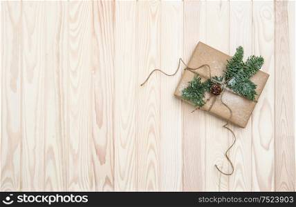 Christmas decoration with wrapped gift and pine tree branches. Holidays background