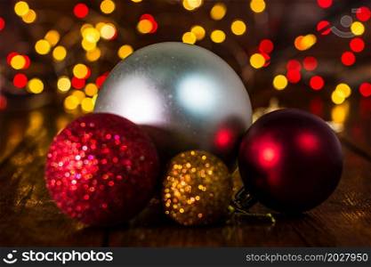 Christmas decorations against blurred background and out of focus lights. Close up of glittery Christmas balls