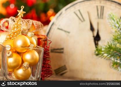 Christmas decorations against old clock at midnight. New year concept