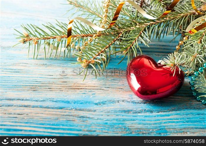 Christmas decorations and fir branch on a blue wooden background