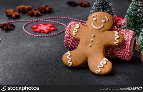 Christmas decorations and gingerbreads on a dark concrete table. Preparing and decorating the house for holiday. Delicious gingerbread cookies with honey, ginger and cinnamon. Winter composition