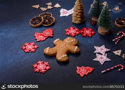 Christmas decorations and gingerbreads on a dark concrete table. Preparing and decorating the house for holiday. Christmas decorations and gingerbreads on a dark concrete table