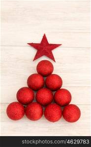 Christmas decorations arranged in tree shape. Red balls
