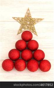 Christmas decorations arranged in tree shape. Red balls and golden star