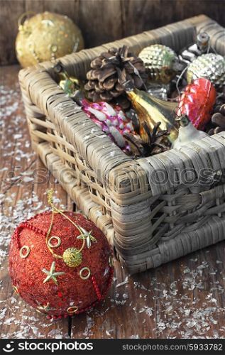 Christmas decorations basket. Braided straw basket full of cones and Christmas ornaments.