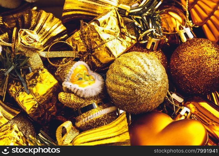 Christmas decorations box with stars, toys and ornaments. Golden baubles and ribbons