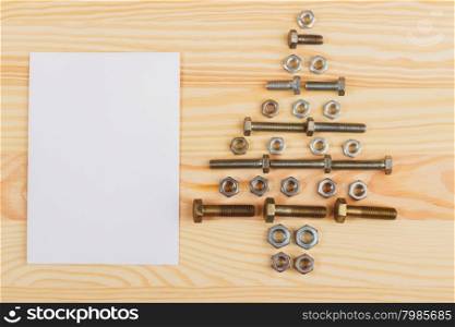Christmas decorations - Christmas tree from hardware. Christmas decorations - Christmas tree from hardware and white card on the wooden background
