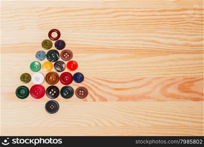 Christmas decorations - Christmas tree of buttons. Christmas decorations - Christmas tree of buttons on the wooden background