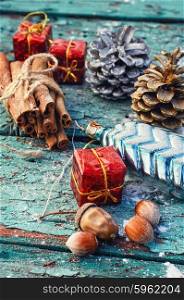 Christmas decorations,cone,cinnamon and nuts on wooden background